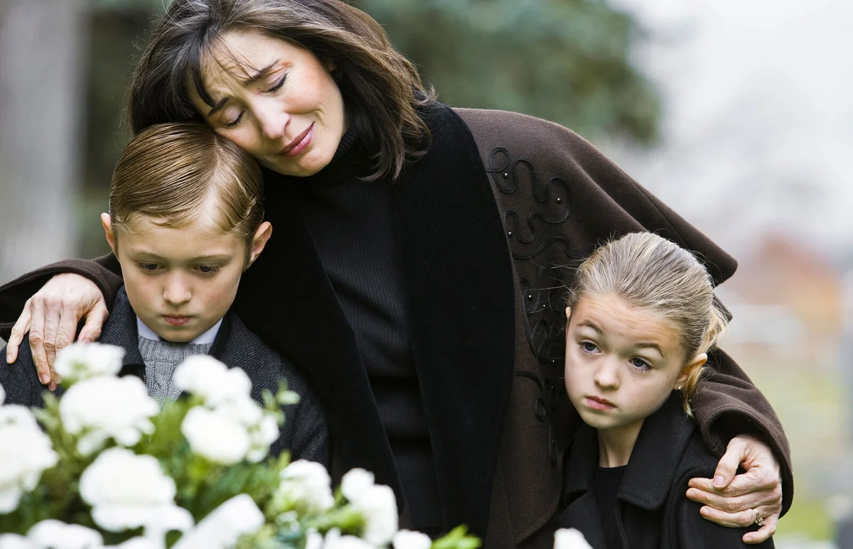 mother and two children at a funeral
