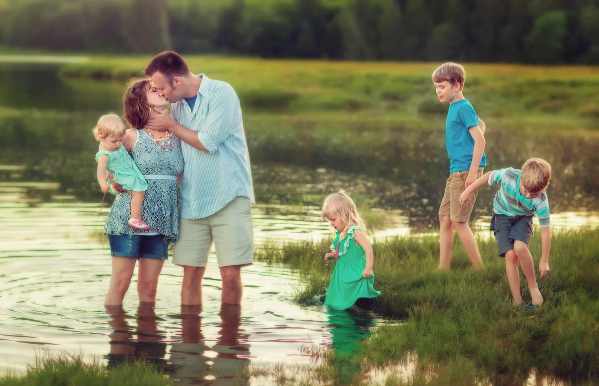 Family of six wading in water
