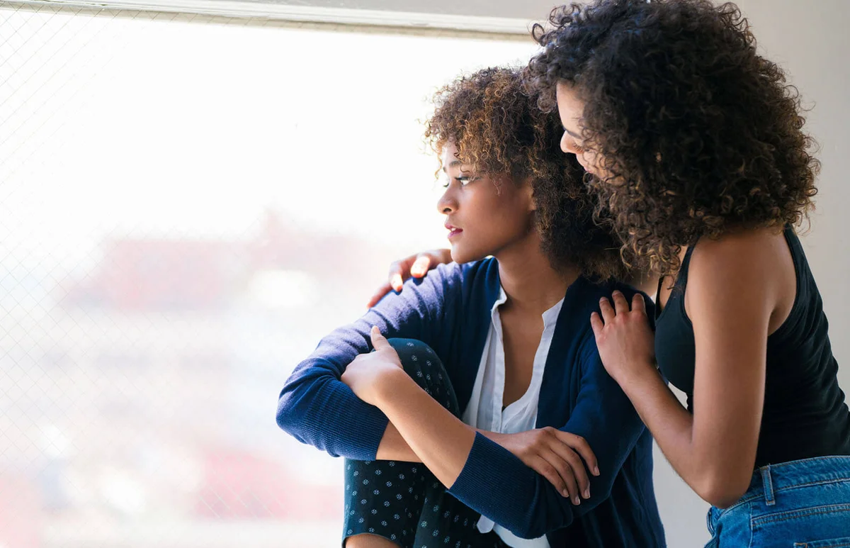 Young woman consoling her friend
