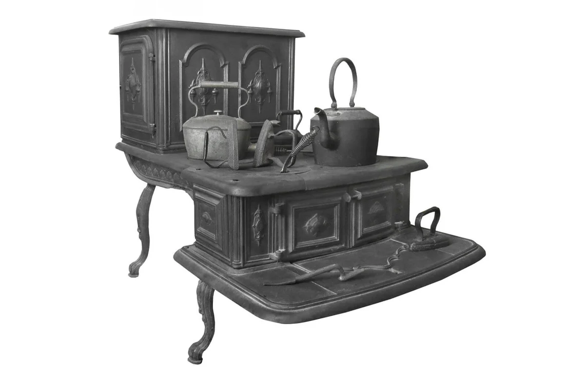 Large old two-level black cast iron wood-burning, cooking stove with pots, kettles, and clothes irons on top | ID 51042399 © Ken Backer | Dreamstime.com