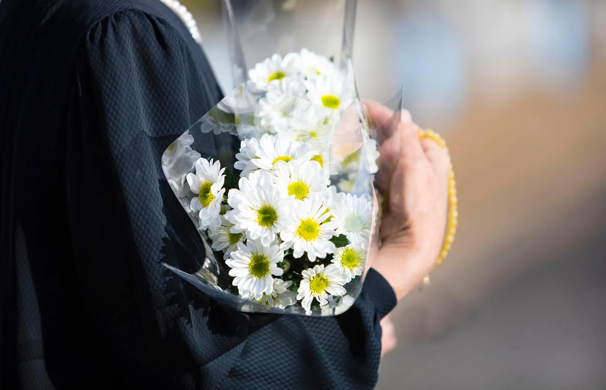 woman with flowers on a funeral