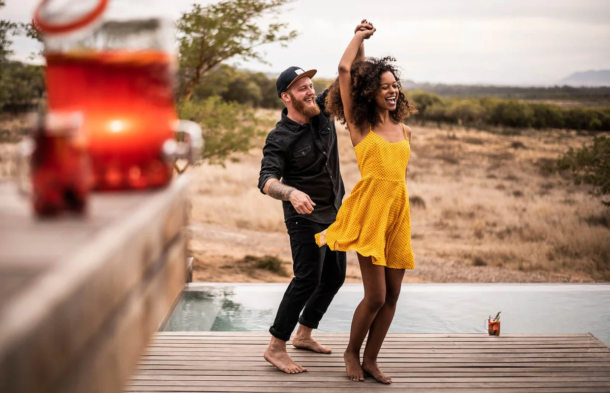 Happy couple dancing on deck of a lodge