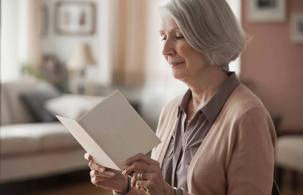 senior woman reading card
