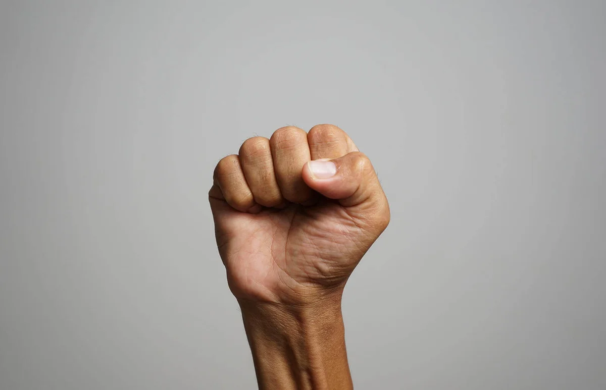 showing fists in right hand