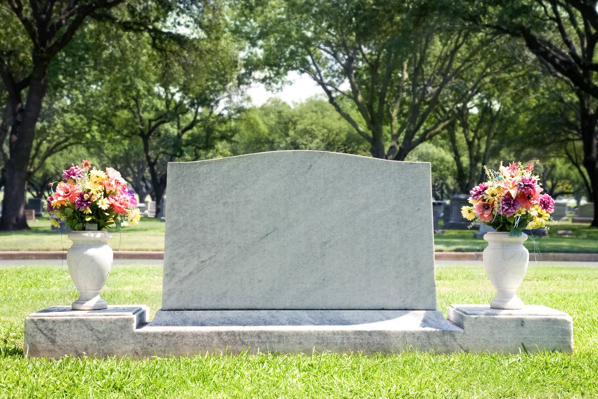 Blank Tombstone at Cemetery with Flowers