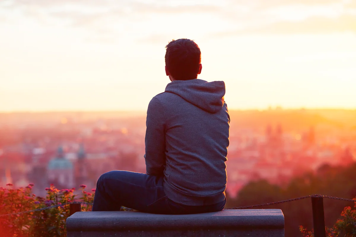 Young man looking at the sunrise