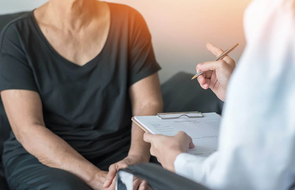 thanatologist speaking with elderly patient