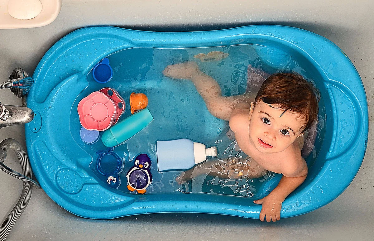 baby covered in soap during bath time
