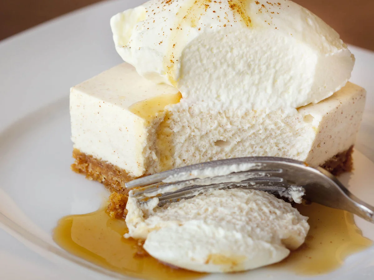 Freshly made cheesecake with whipped cream and caramel