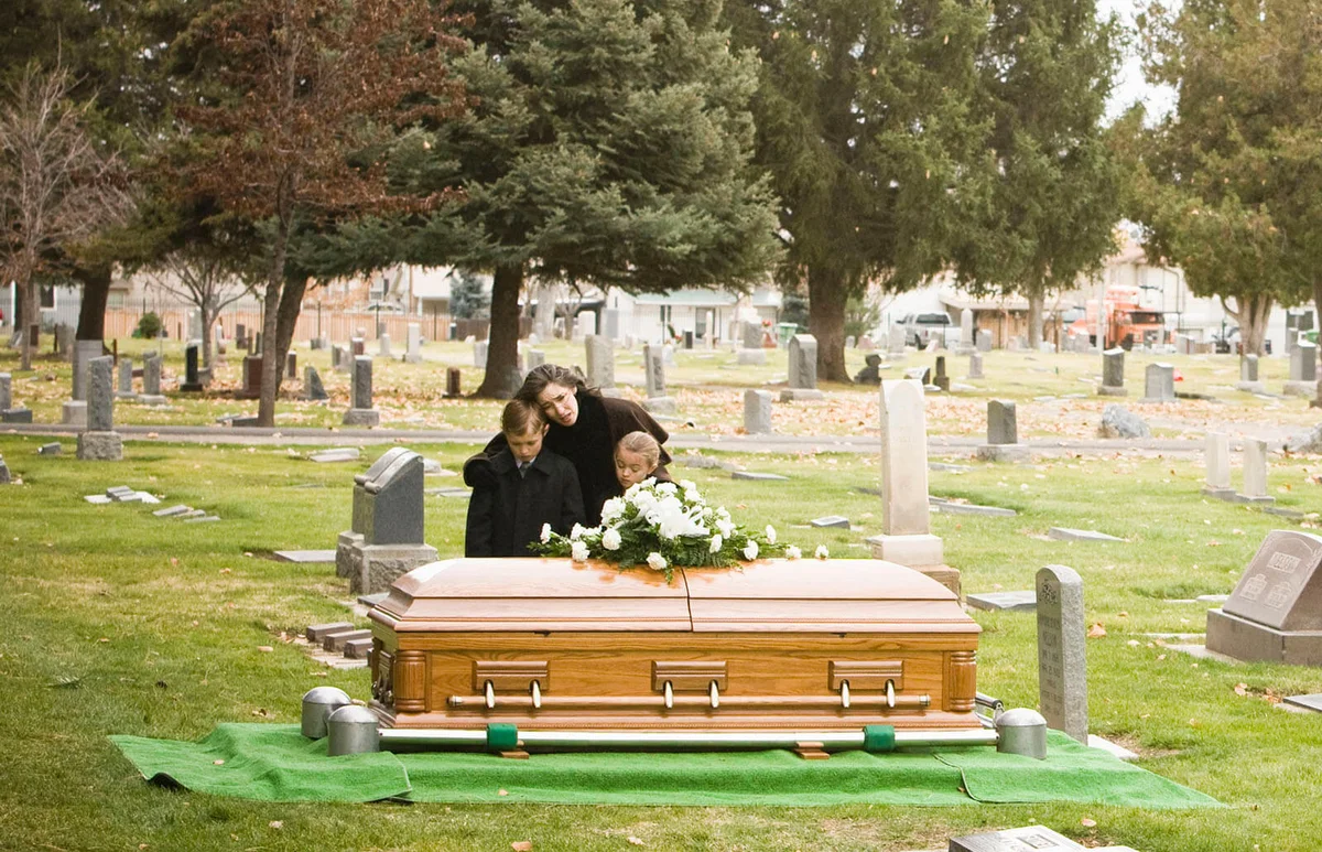 people at a funeral in a cemetery