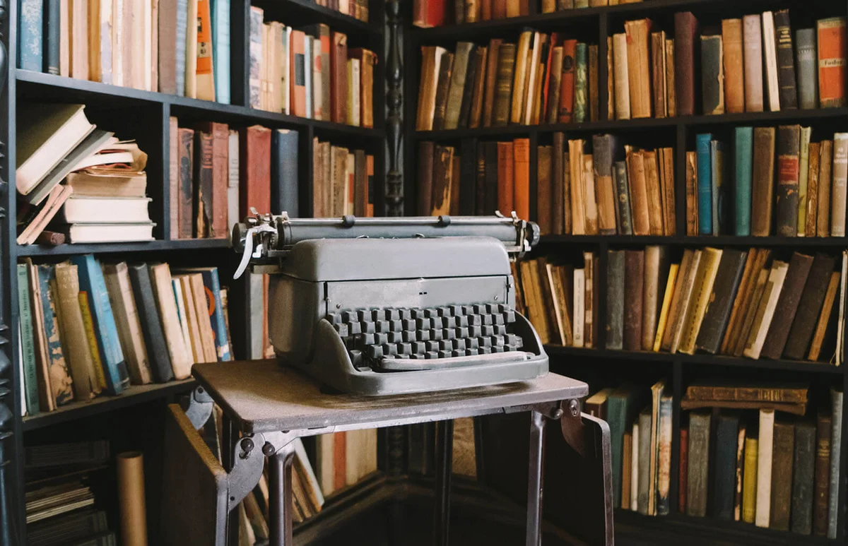 Interior of abandoned ornate Colonial Villa with books and typewriter