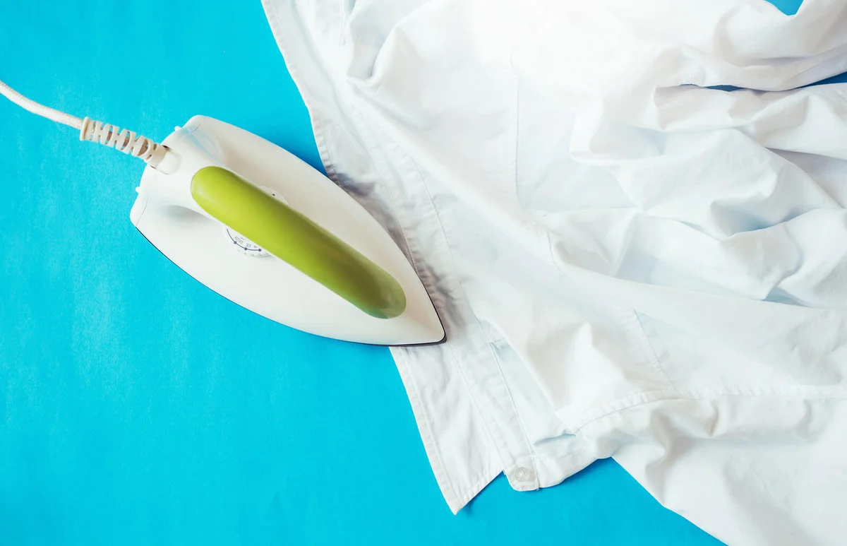 Iron With Shirt On Ironing Board