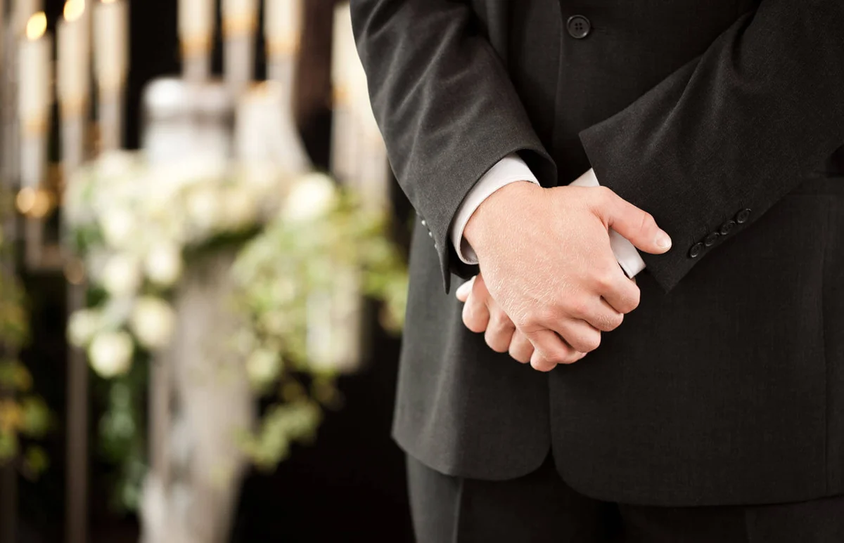 man at funeral mourning