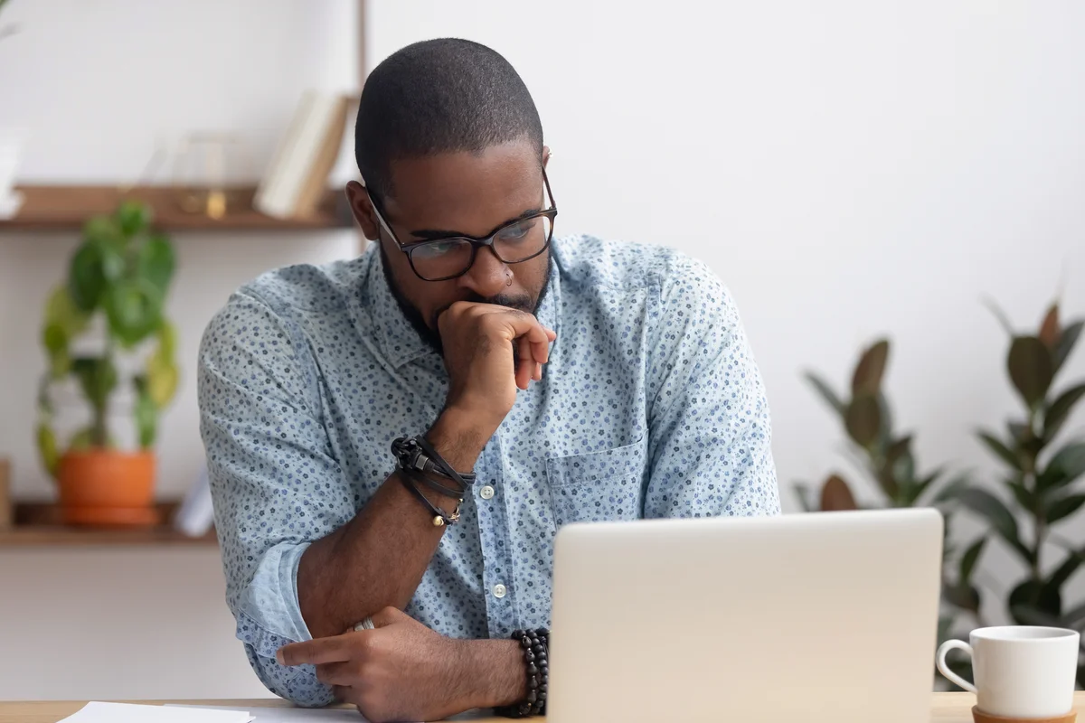 Man reading sad news on computer