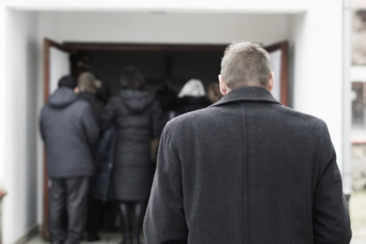 Family entering mausoleum for funeral service