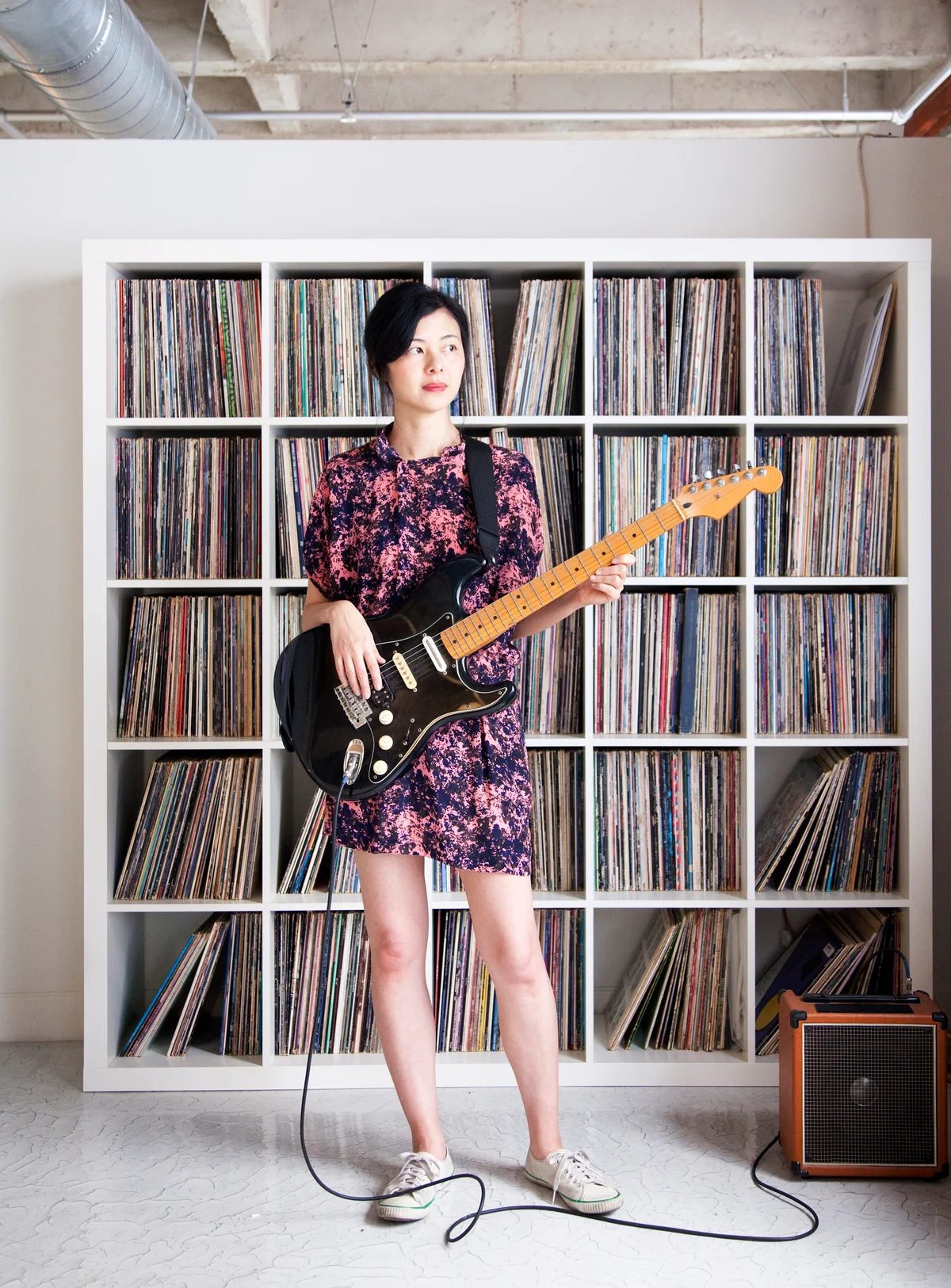 record storage unit and woman playing guitar