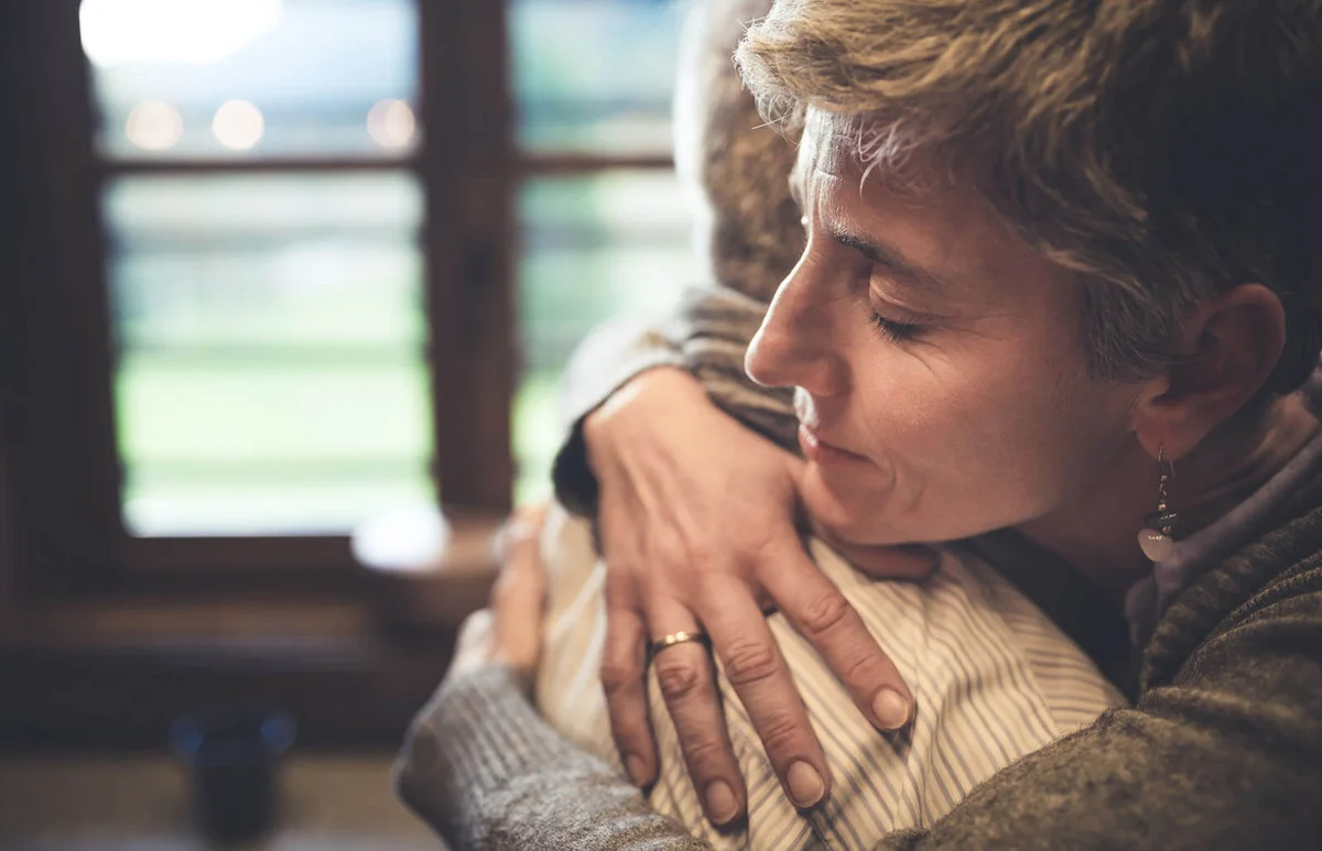 Senior couple embrace in kitchen