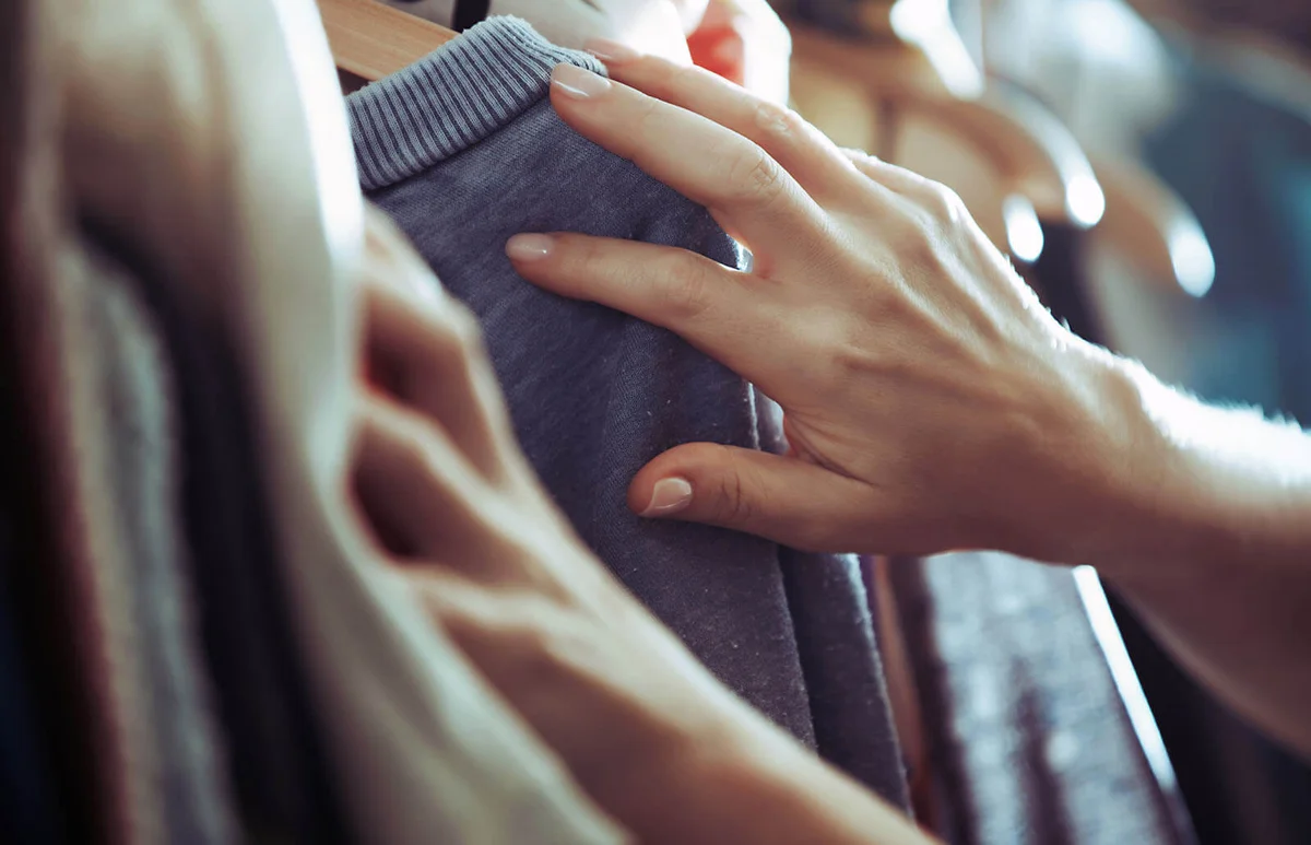 Woman choosing clothes at boutique