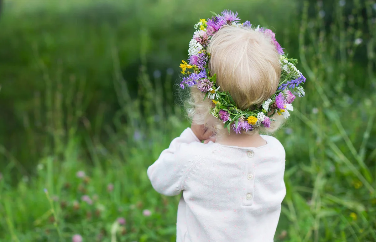 mall girl with blond curly hair wearing colorful wreath