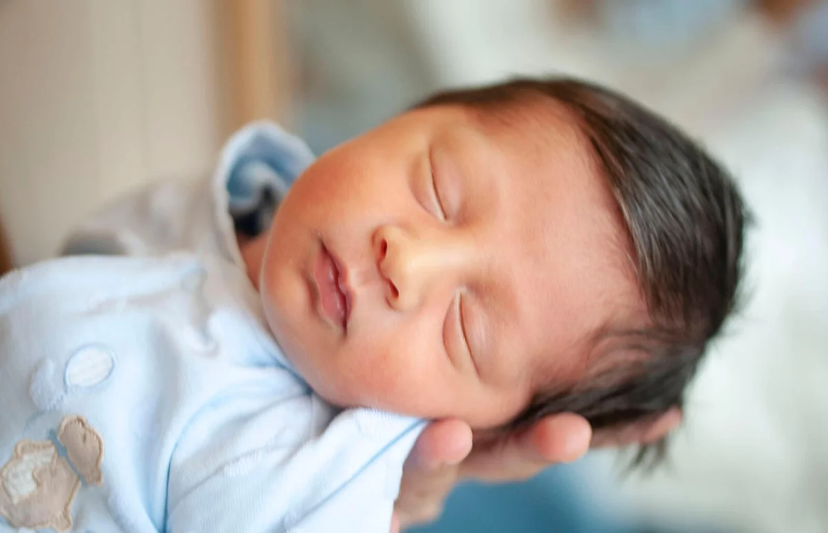 Mother holding her newborn baby boy