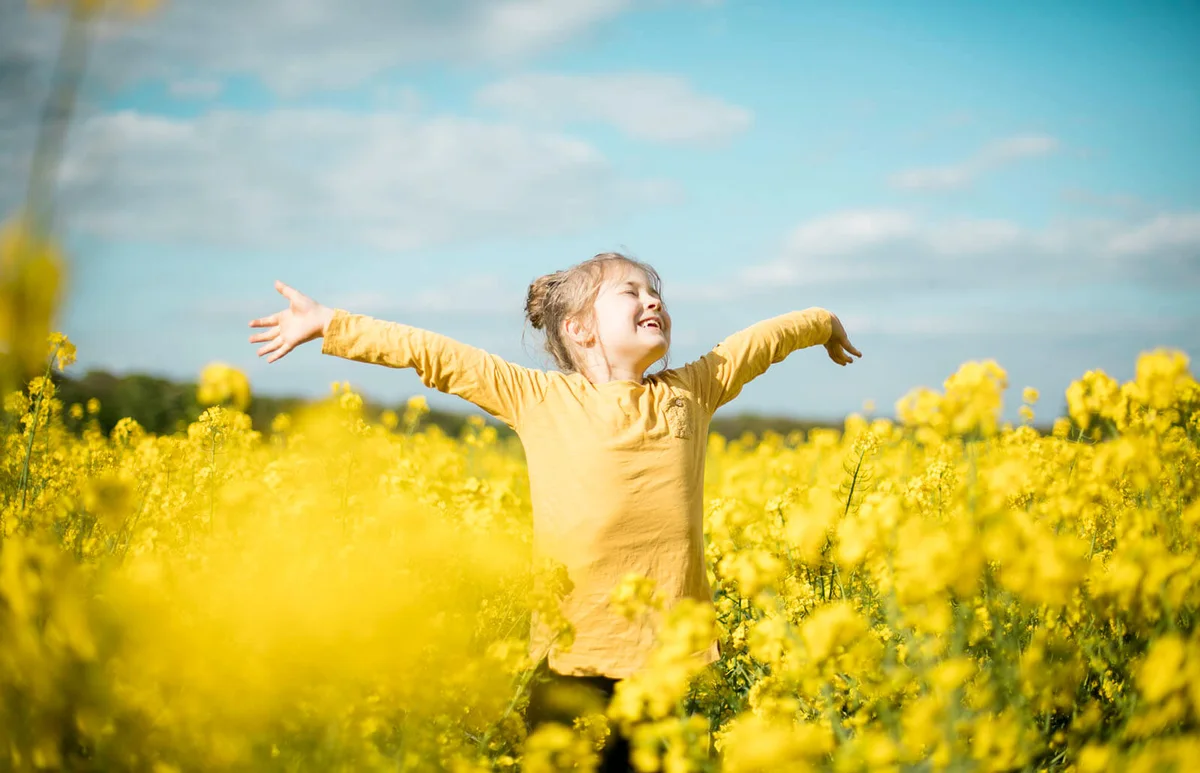 Carefree girl in rape field