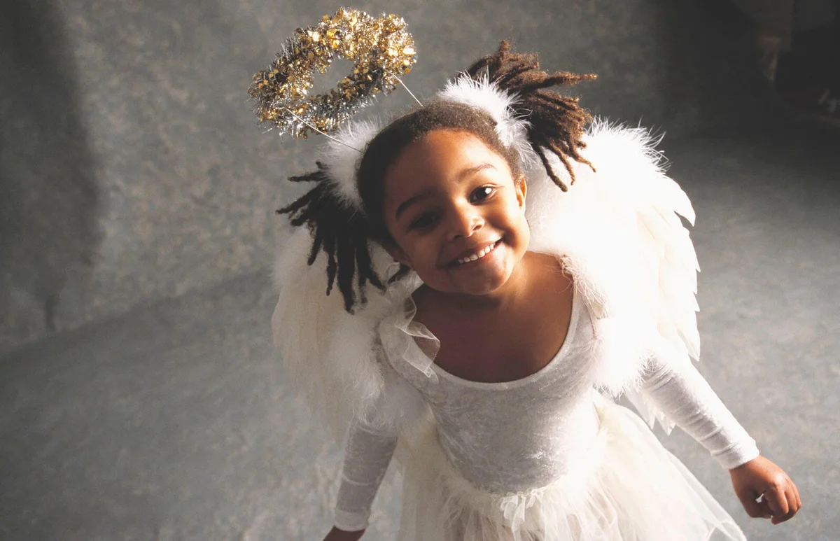 girl smiling in angel costume