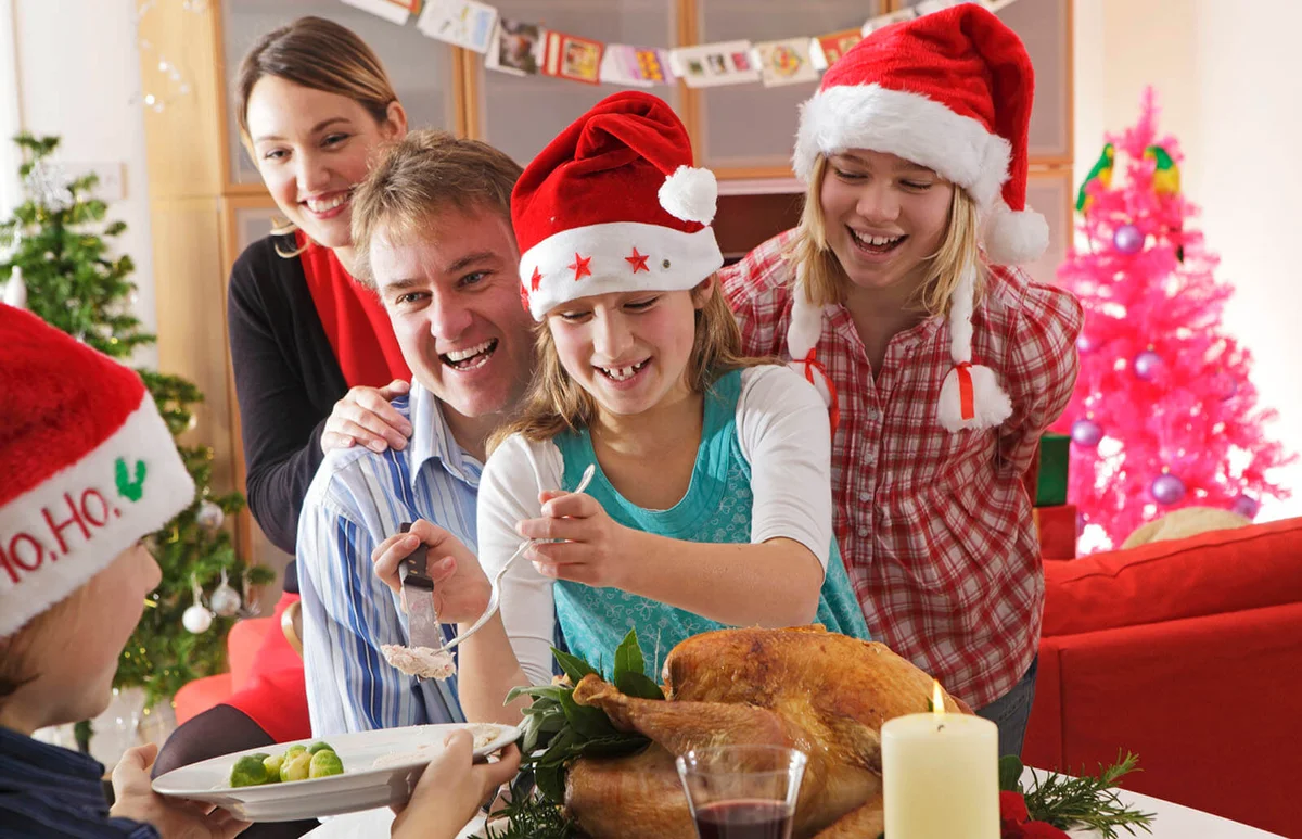Family serving christmas dinner