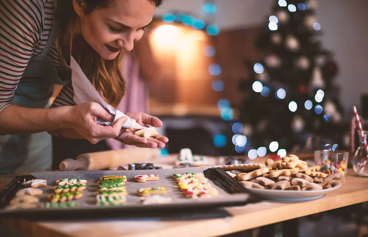 woman decorating a Gingerbread cookies for Christmas