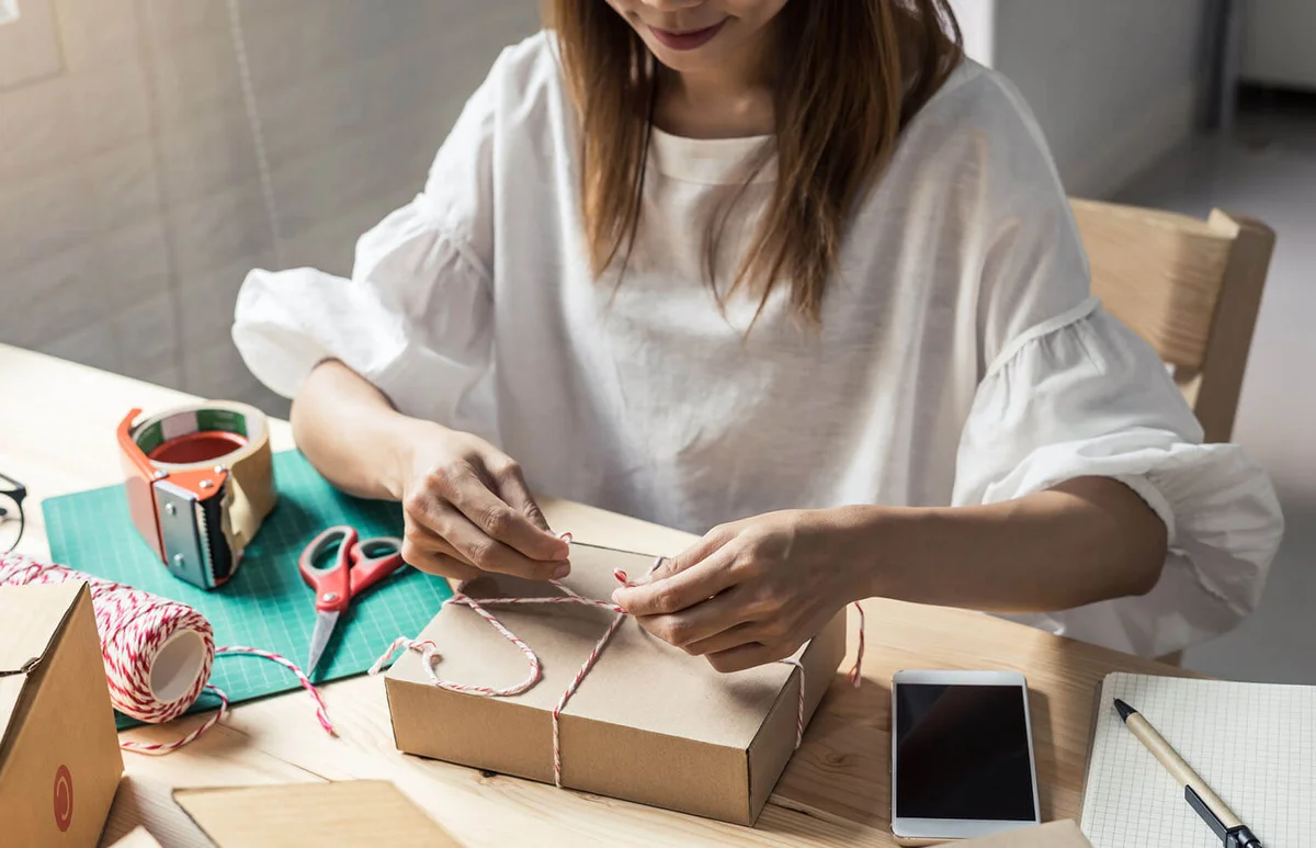 Woman packing gift box