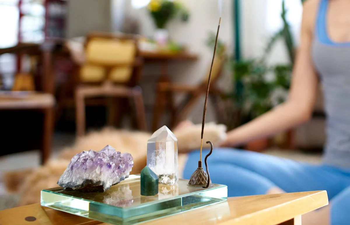 Woman at home with incense and crystals