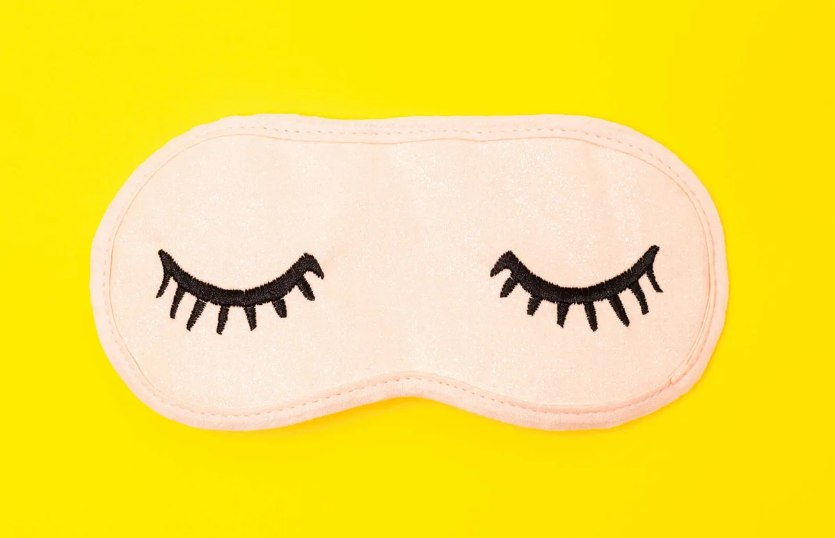 Eye Mask Over Yellow Background