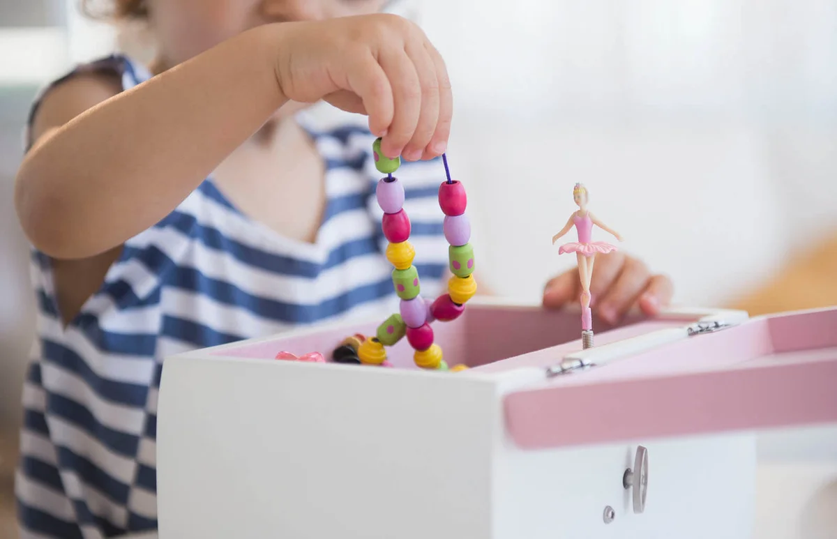 girl taking jewelry from jewelry box