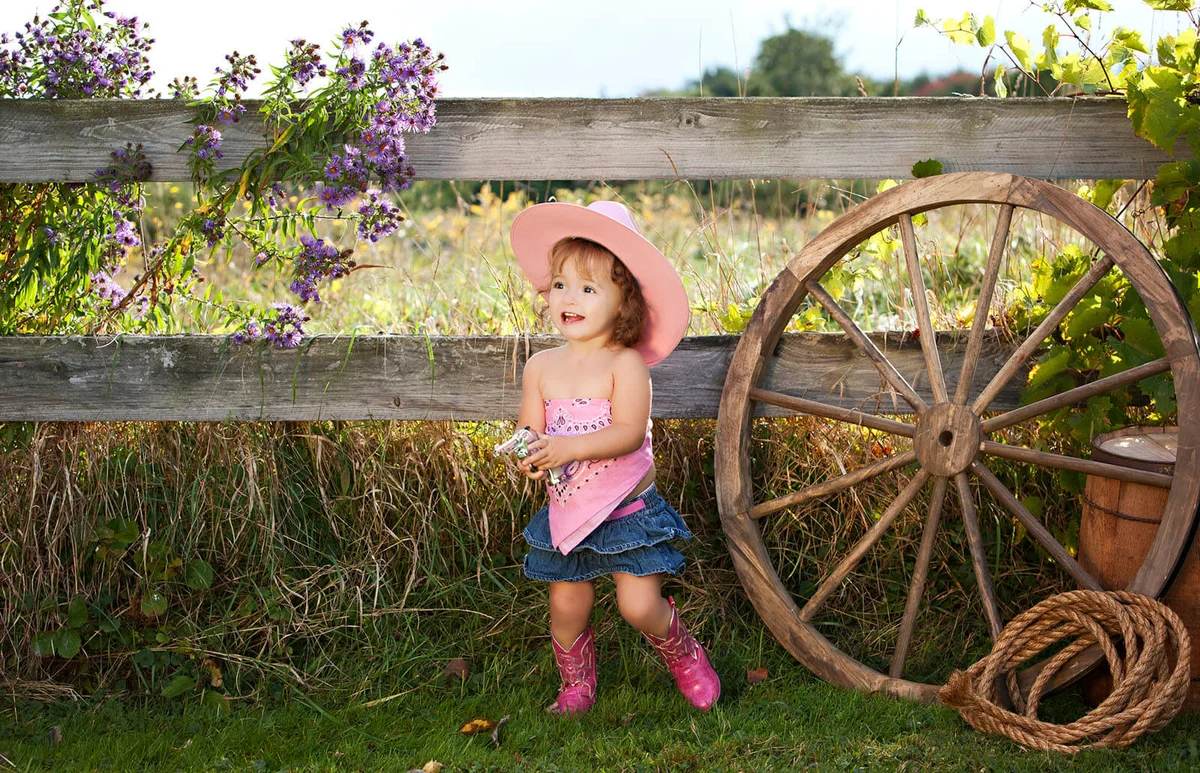 Adorable toddler dressed as a cowgirl.