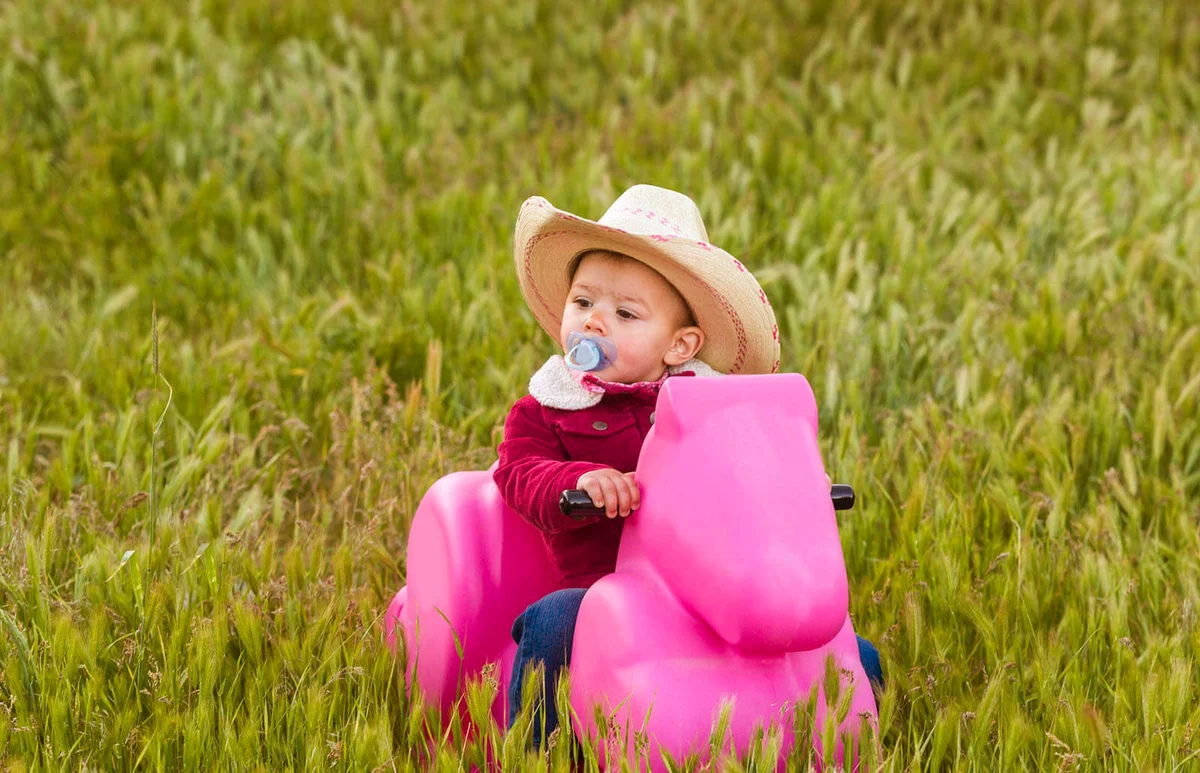 young baby girl playing at countryside