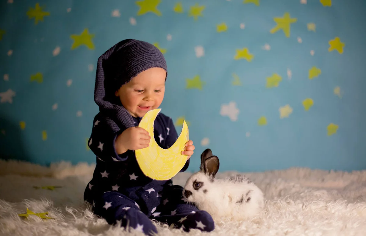 baby boy with cute white bunny and moon on a blue star