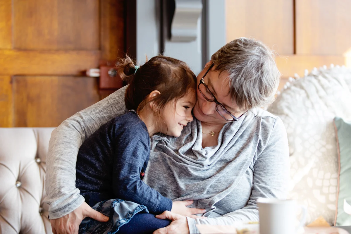 Little girl is sitting with her grandmother