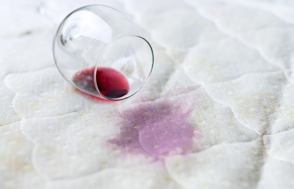 Spilled wine glass on the bed