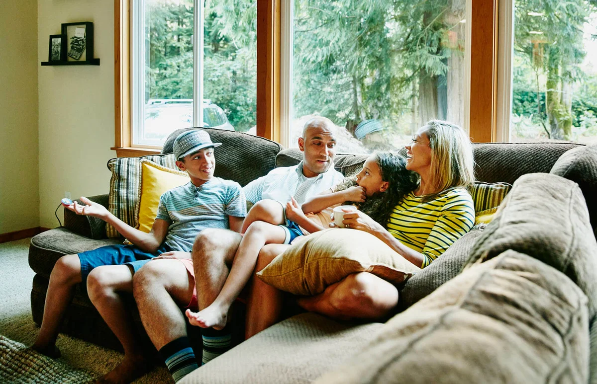 Family sitting together on couch in living room