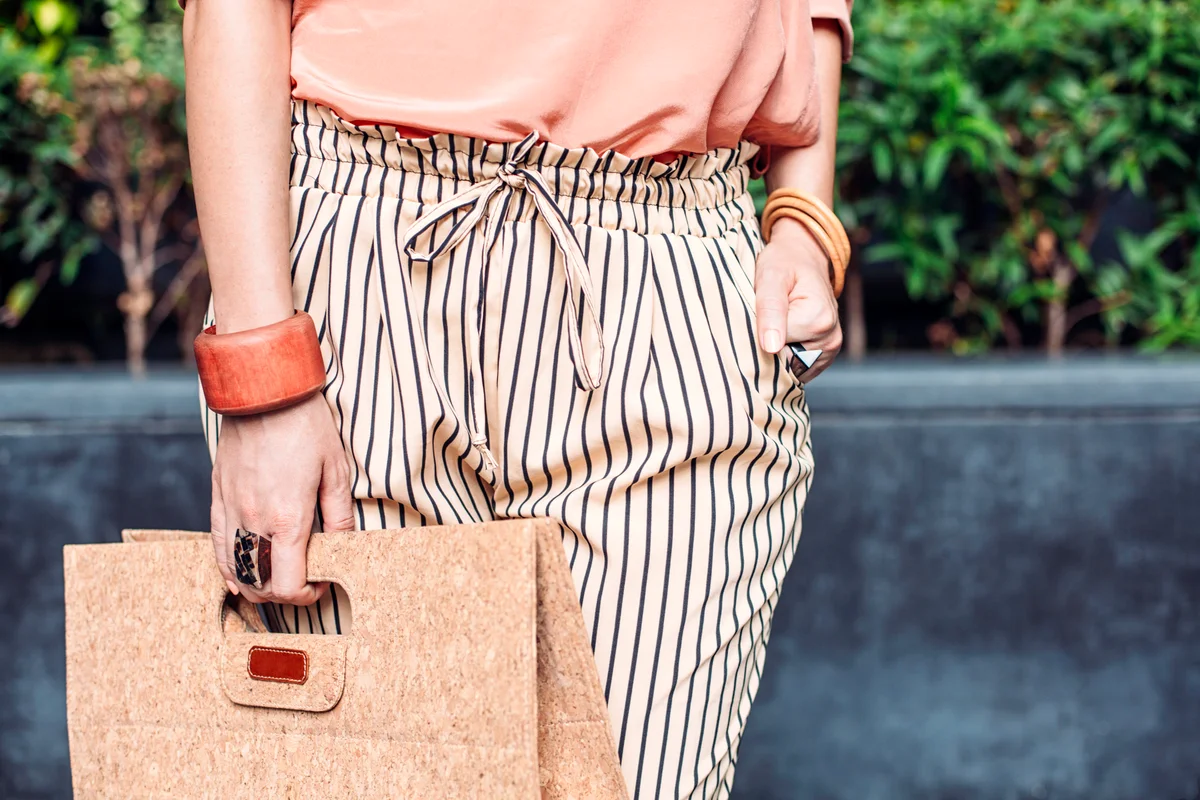 Stylish woman carrying purse outdoors