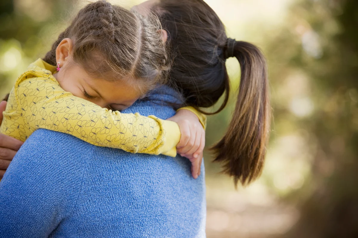 Woman hugging her daughter