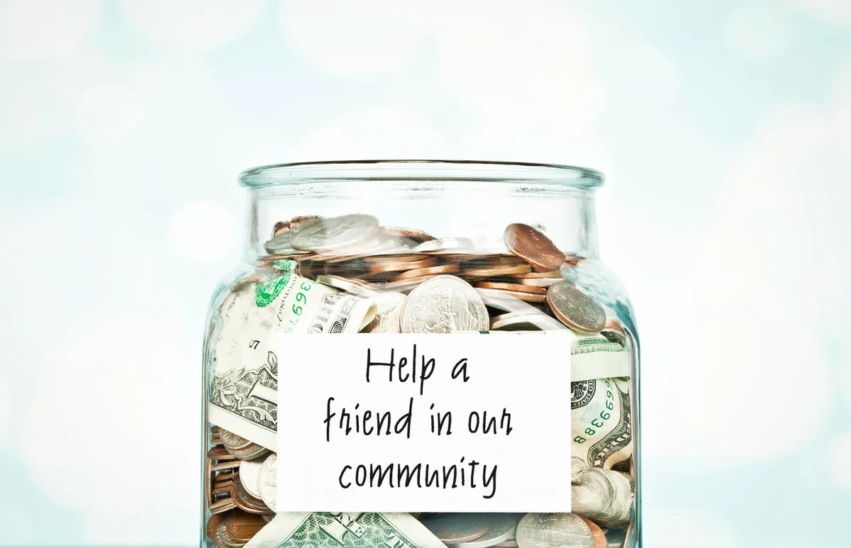 Glass jar filled with donated money for a fundraiser