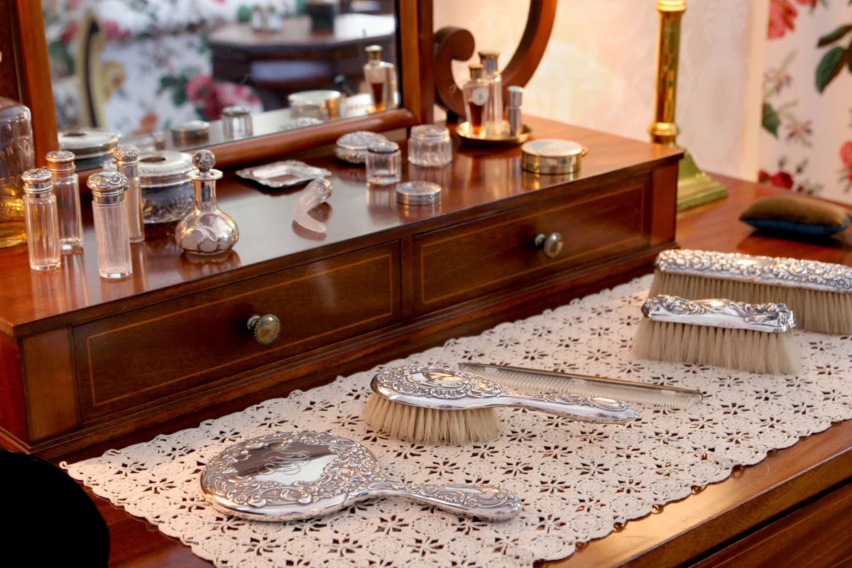 Beauty products on antique dressing table