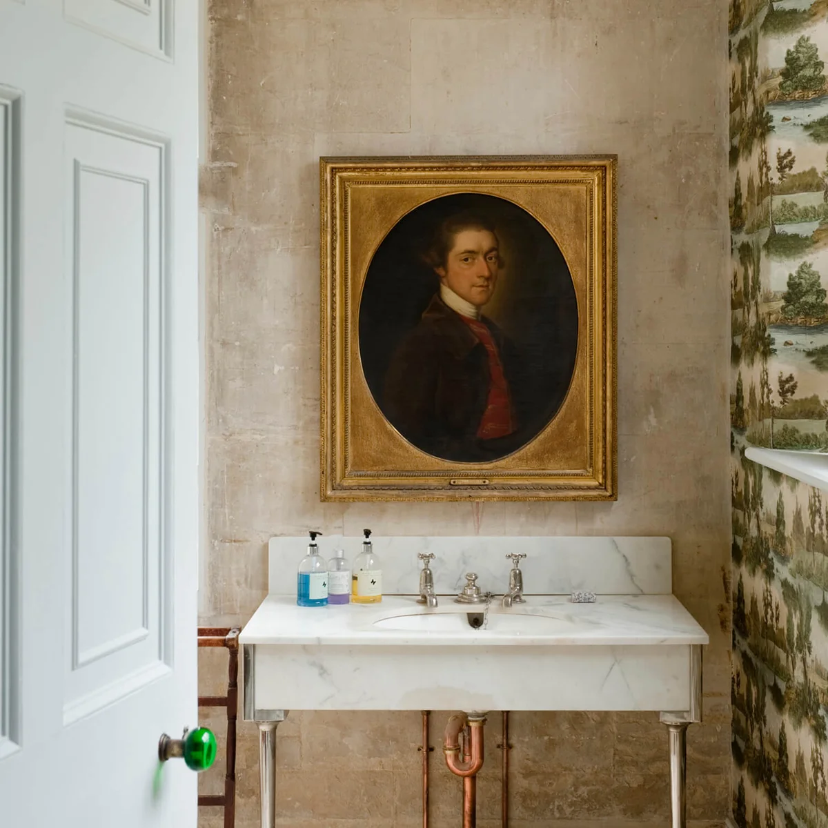 Oil painting above washbasinin Gloucestershire country estate house