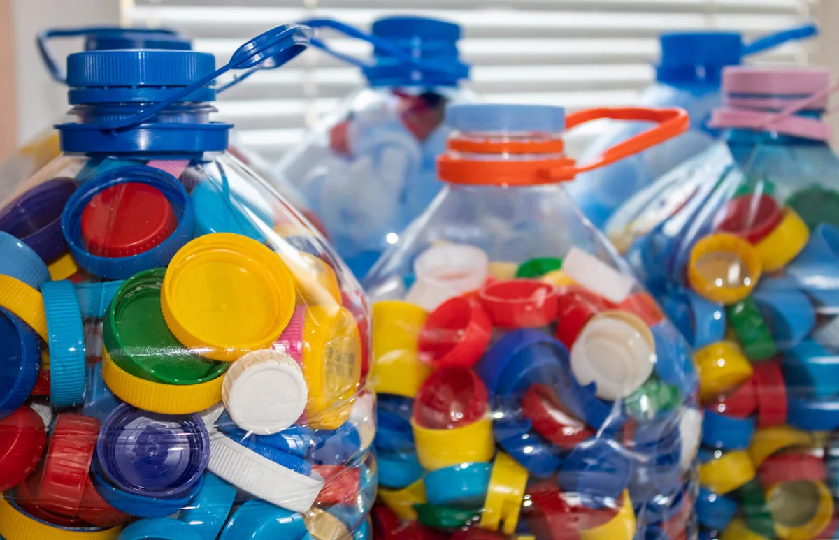 5 liter plastic bottles full of colorful plastic caps