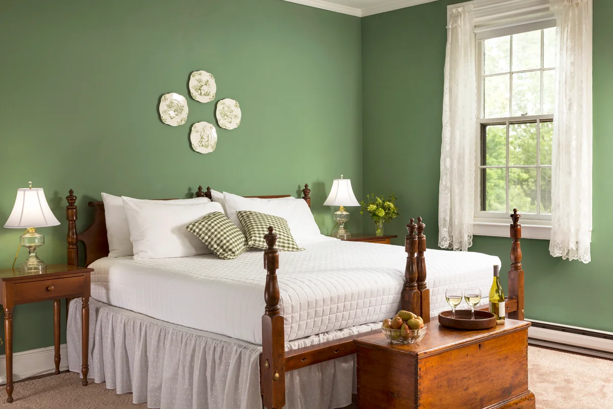 Two beds together in green bedroom