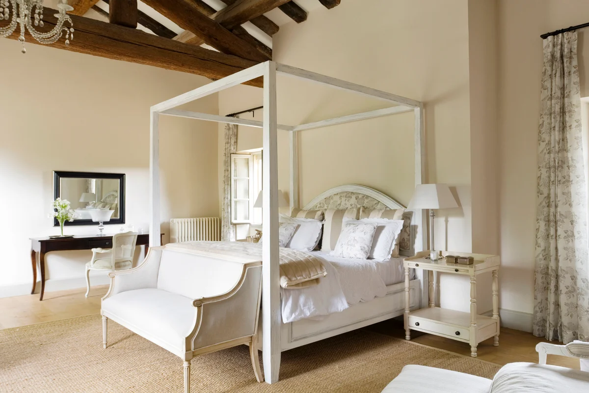 French country house in Provence with a vintage bench in the bedroom