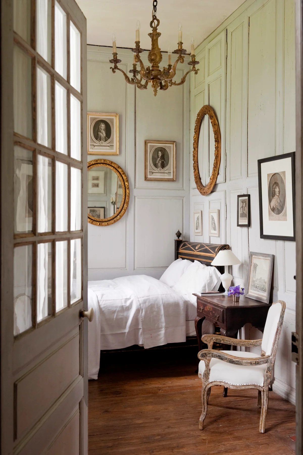 Charming bedroom with wooden wall panelling and french antiques