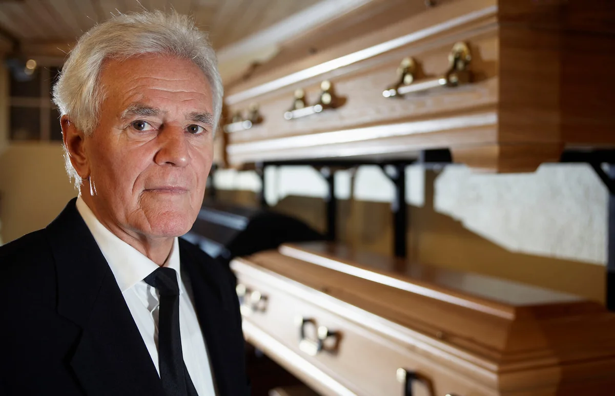Man Standing in Funeral Parlor