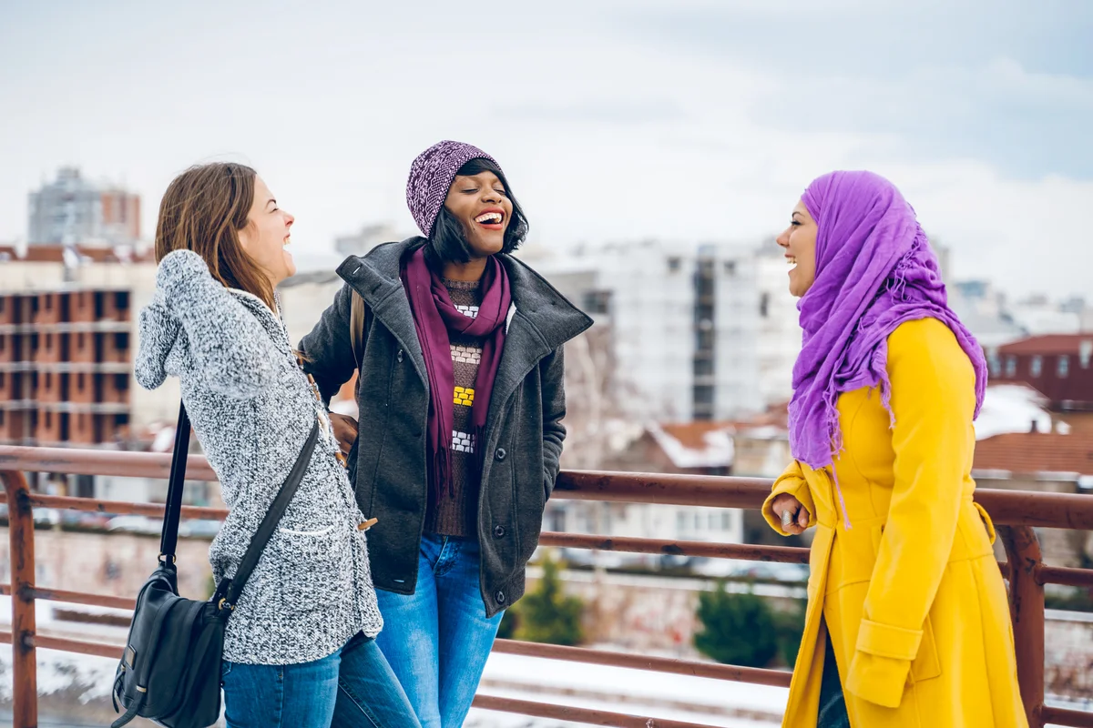 Multi-ethnic group of female friends are chatting during winter walk