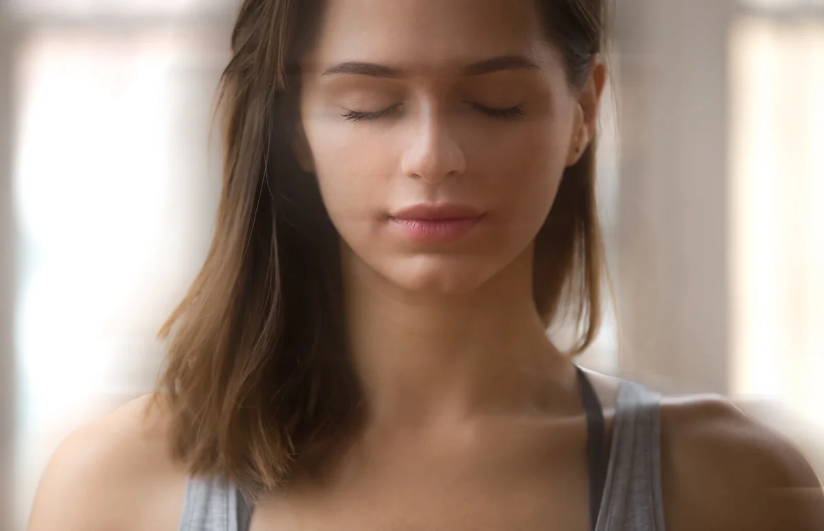 Portrait of attractive yogi woman meditating